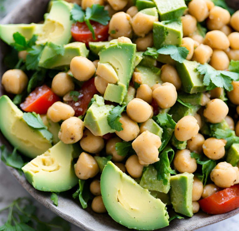 A close-up of Avocado Chickpea Salad with avocado chunks, chickpeas, cherry tomatoes, and fresh parsley.