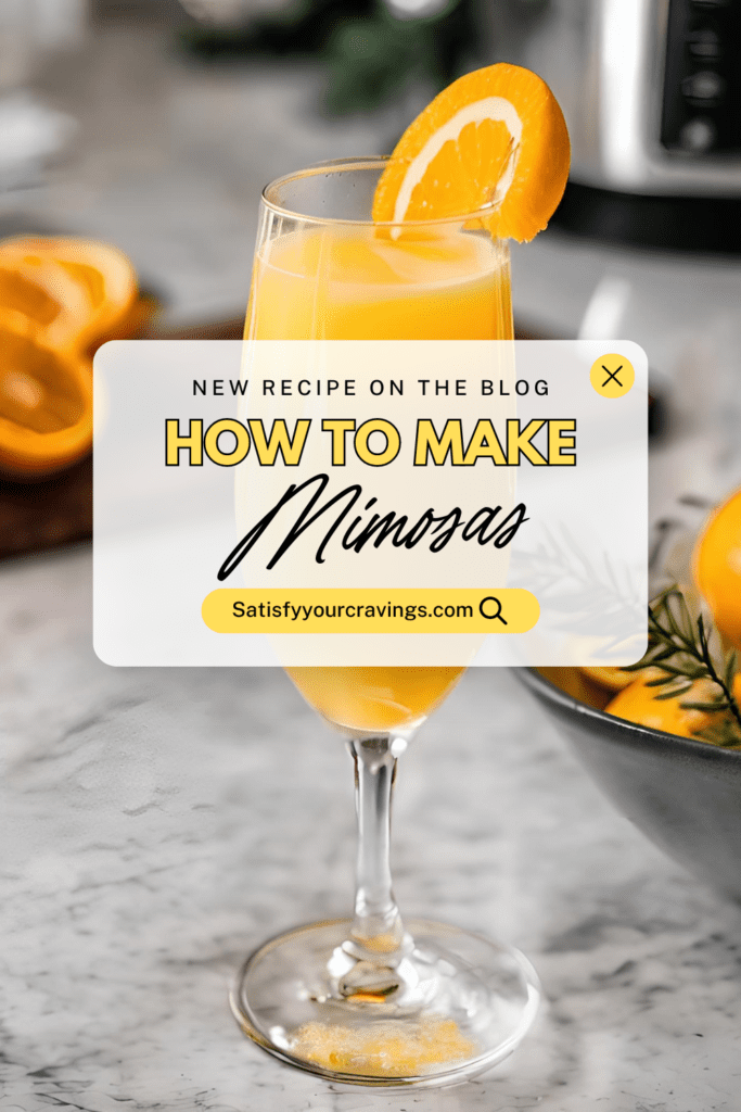 Freshly poured Mimosa in a tall champagne flute garnished with an orange slice, surrounded by halved oranges and rosemary sprigs on a marble countertop.