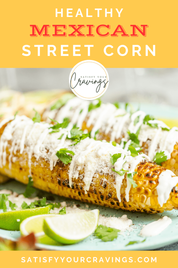 Grilled Mexican Street Corn (Elotes) topped with creamy sauce, crumbled cotija cheese, and fresh cilantro, served with lime wedges on a green plate.