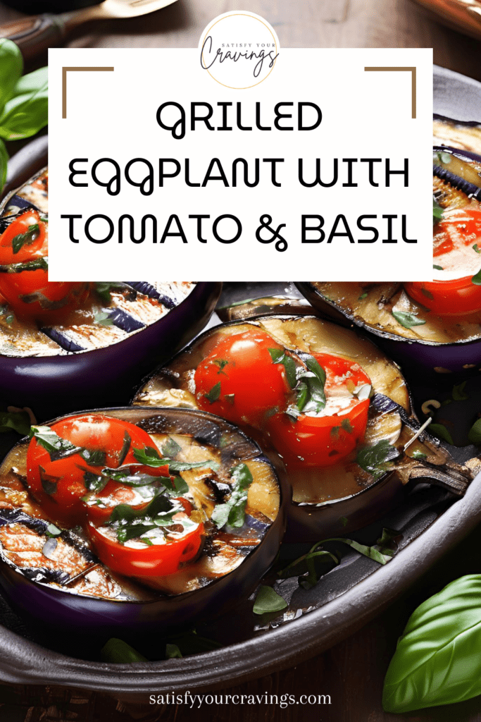 Grilled eggplant halves topped with fresh tomato slices and basil on a rustic wooden table, styled for a culinary blog post.