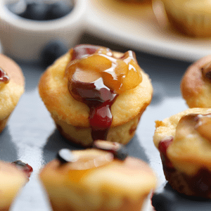 Mini Pancake Bites topped with syrup and fruit.