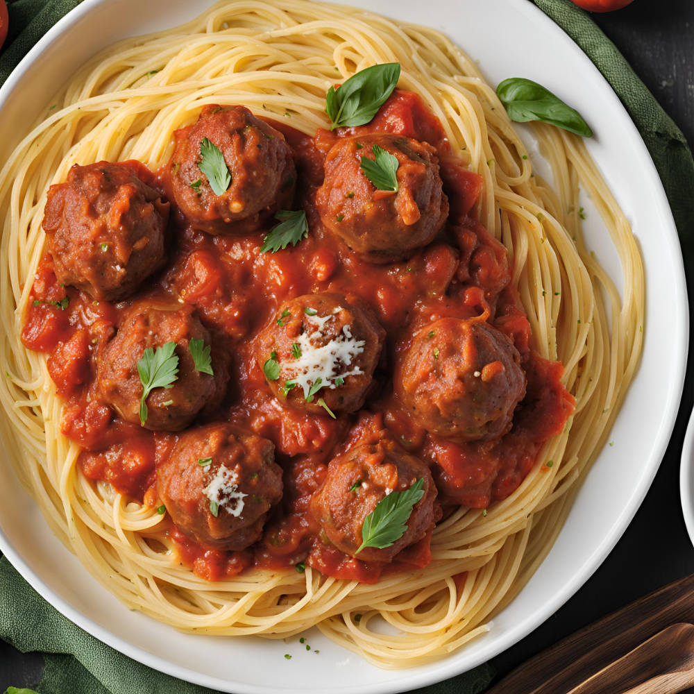 A close-up of spaghetti with meatballs in a rich tomato sauce, garnished with parsley and Parmesan