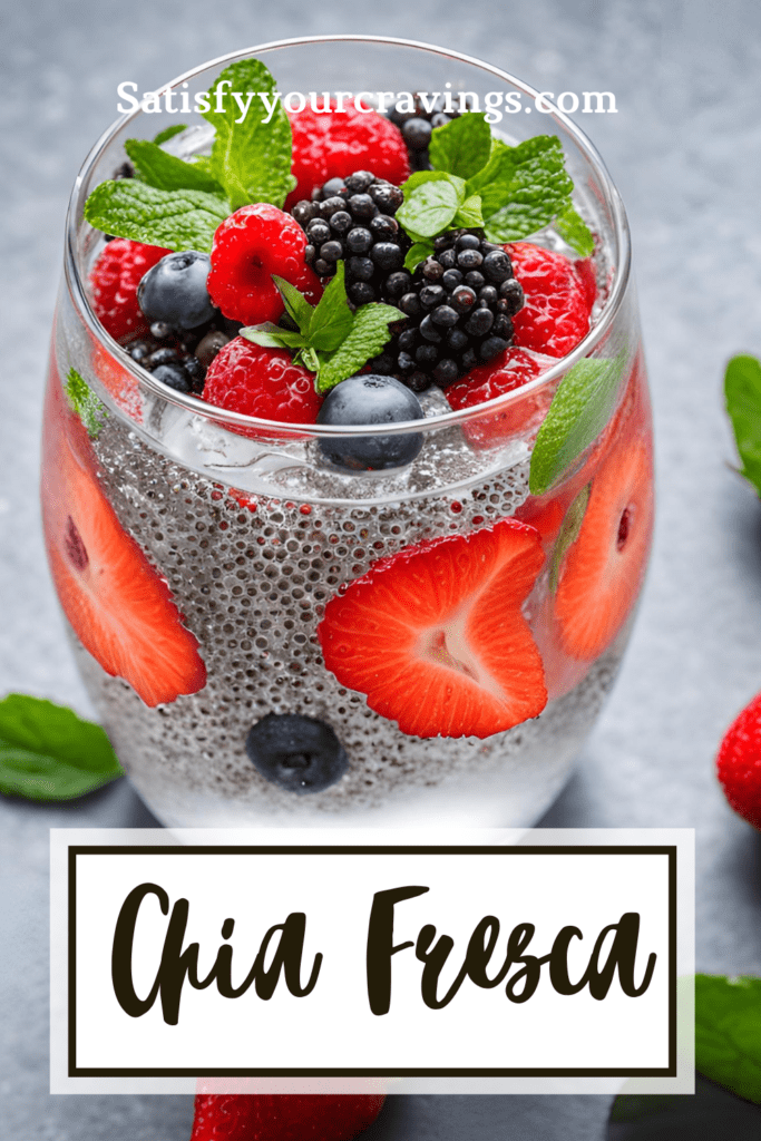 Close-up of chia fresca in a glass, topped with fresh strawberries, blackberries, blueberries, and mint leaves, with the text 'Satisfyyourcravings.com' overlaid.