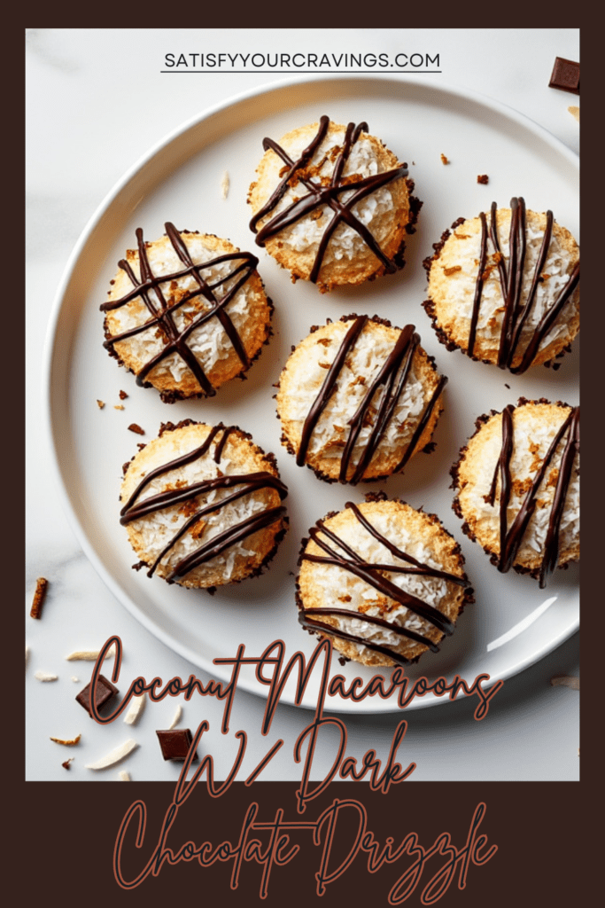 Coconut macaroons with dark chocolate drizzle and coconut flakes on a white plate.