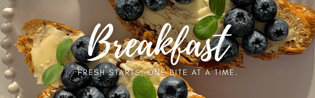 Breakfast banner with crostini topped with creamy spread and fresh blueberries, featuring the text “Breakfast – Fresh starts, one bite at a time.”